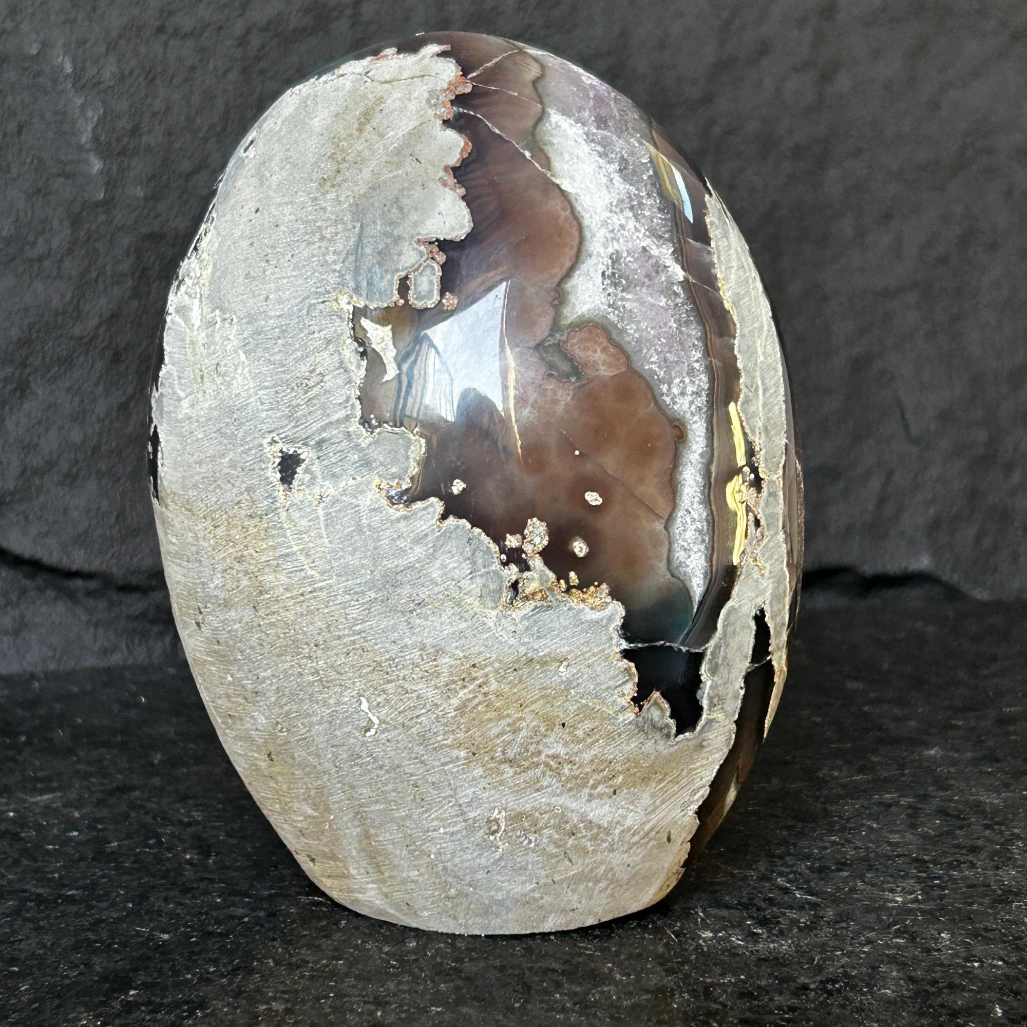 Polished agate stone on a dark gray background