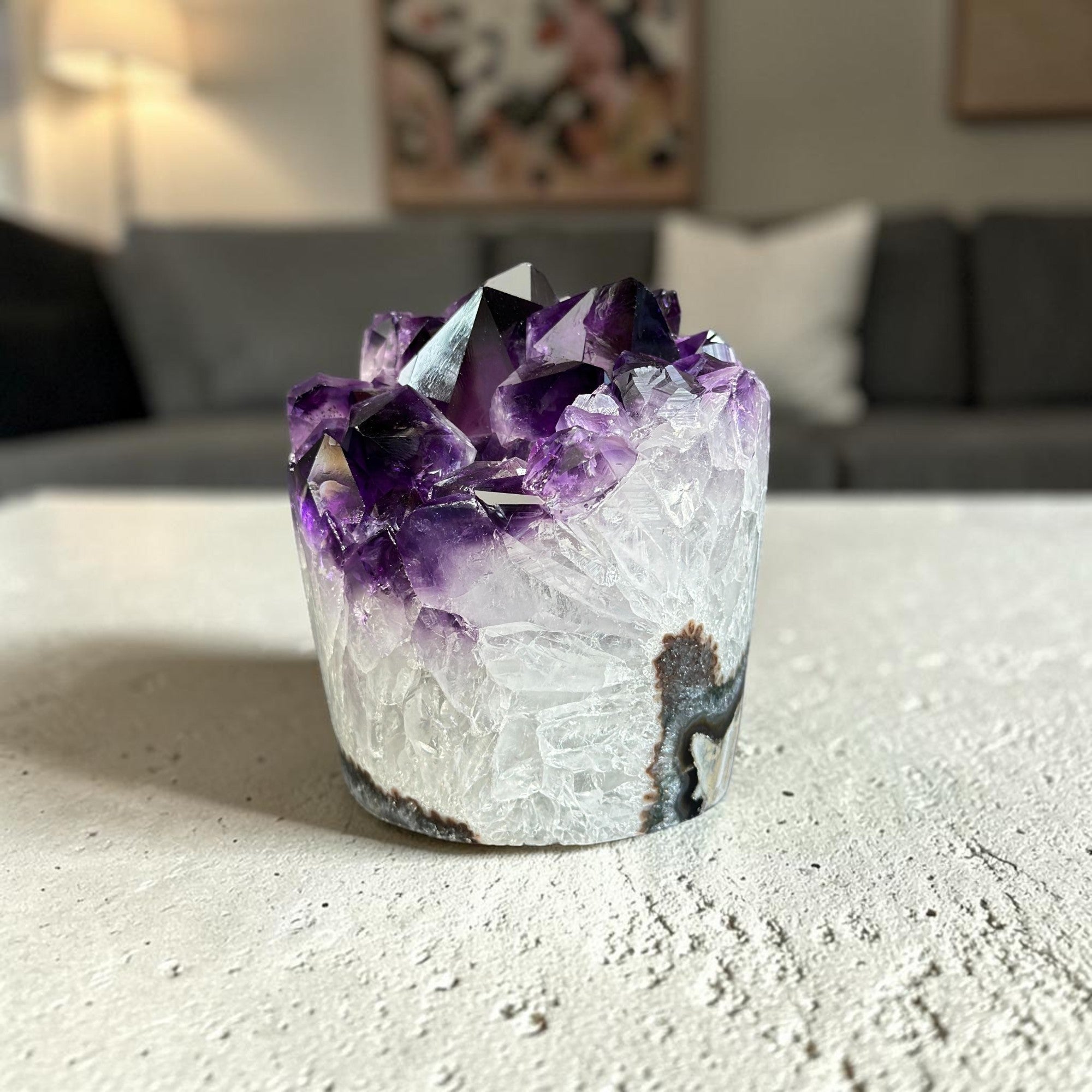 extra large amethyst with white quartz formations on a surface