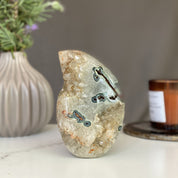 Polished agate flame decor with green and red crystal formations, 5-inch tall.