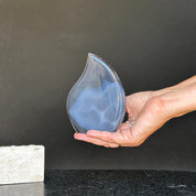 Polished blue agate and quartz flame crystal, 5-inch tall, held in a hand.