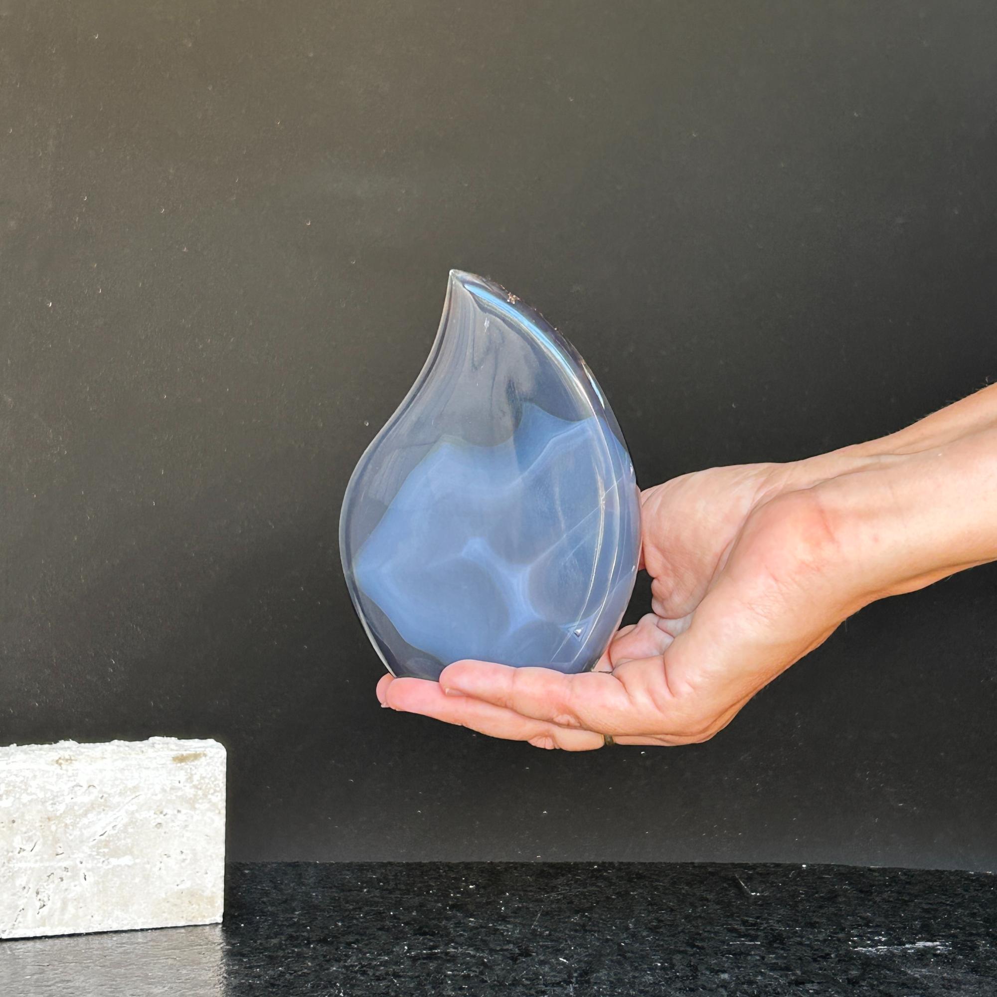 Polished blue agate and quartz flame crystal, 5-inch tall, held in a hand.