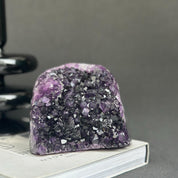 Huge Uruguayan amethyst cave geode with deep purple crystals and dark agate formations.