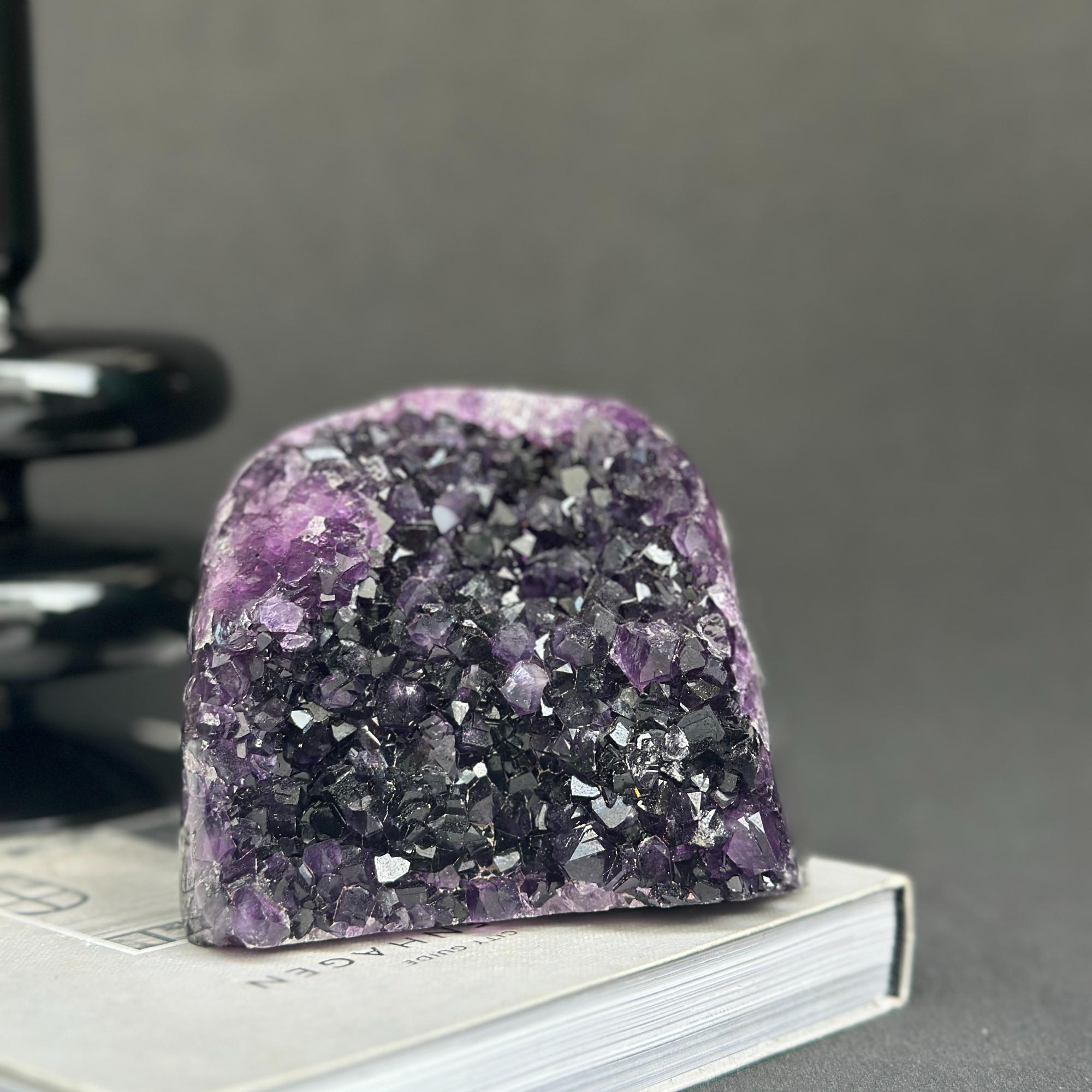 Huge Uruguayan amethyst cave geode with deep purple crystals and dark agate formations.