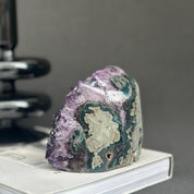 Huge Uruguayan amethyst cave geode with deep purple crystals and green agate formations.