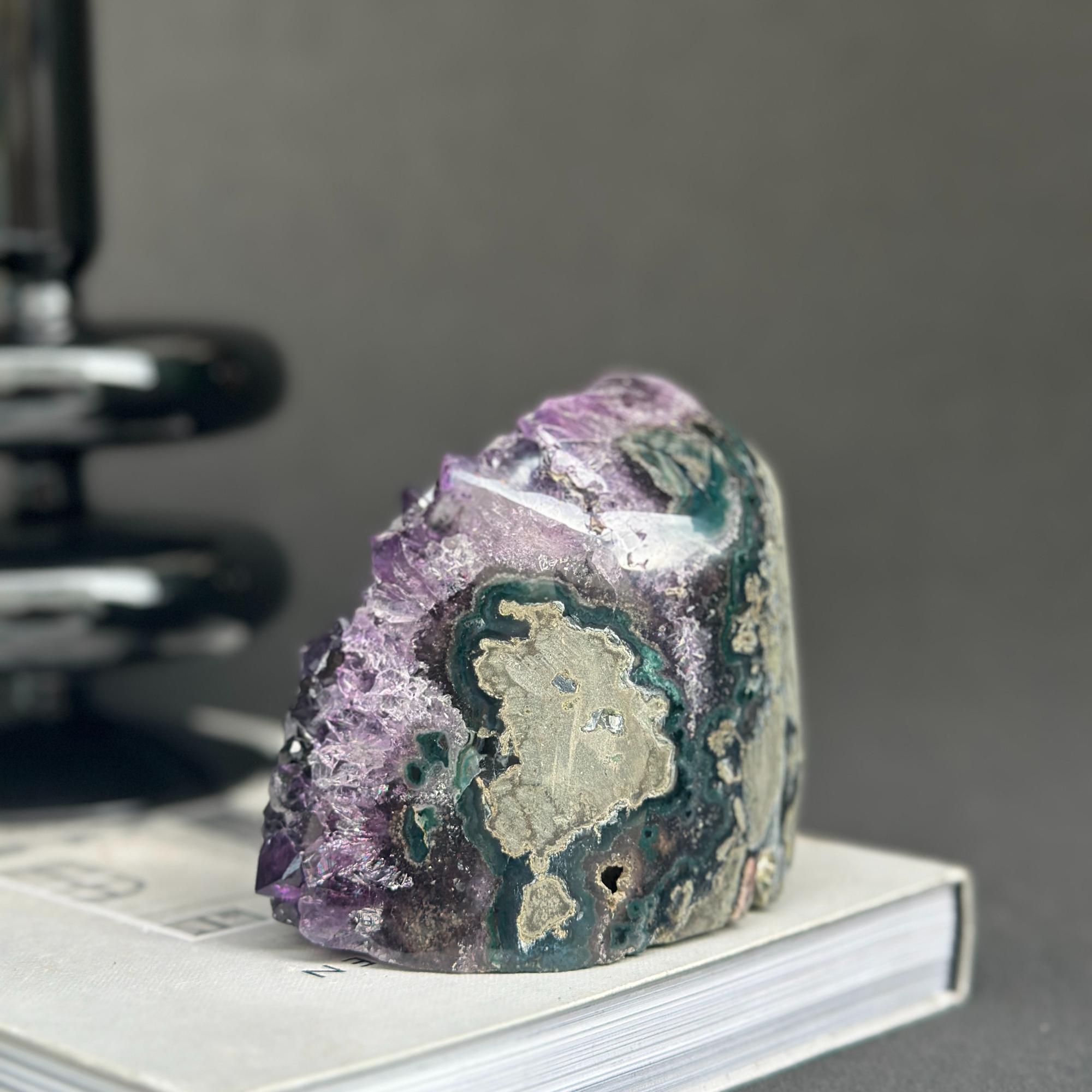 Huge Uruguayan amethyst cave geode with deep purple crystals and green agate formations.