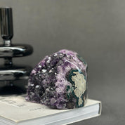 Huge Uruguayan amethyst cave geode with deep purple crystals and green agate formations.