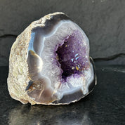 Extra large Uruguayan amethyst geode with deep purple crystals and striking agate edges.