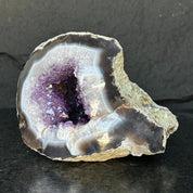 Extra large Uruguayan amethyst geode with deep purple crystals and striking white and dark agate edges.