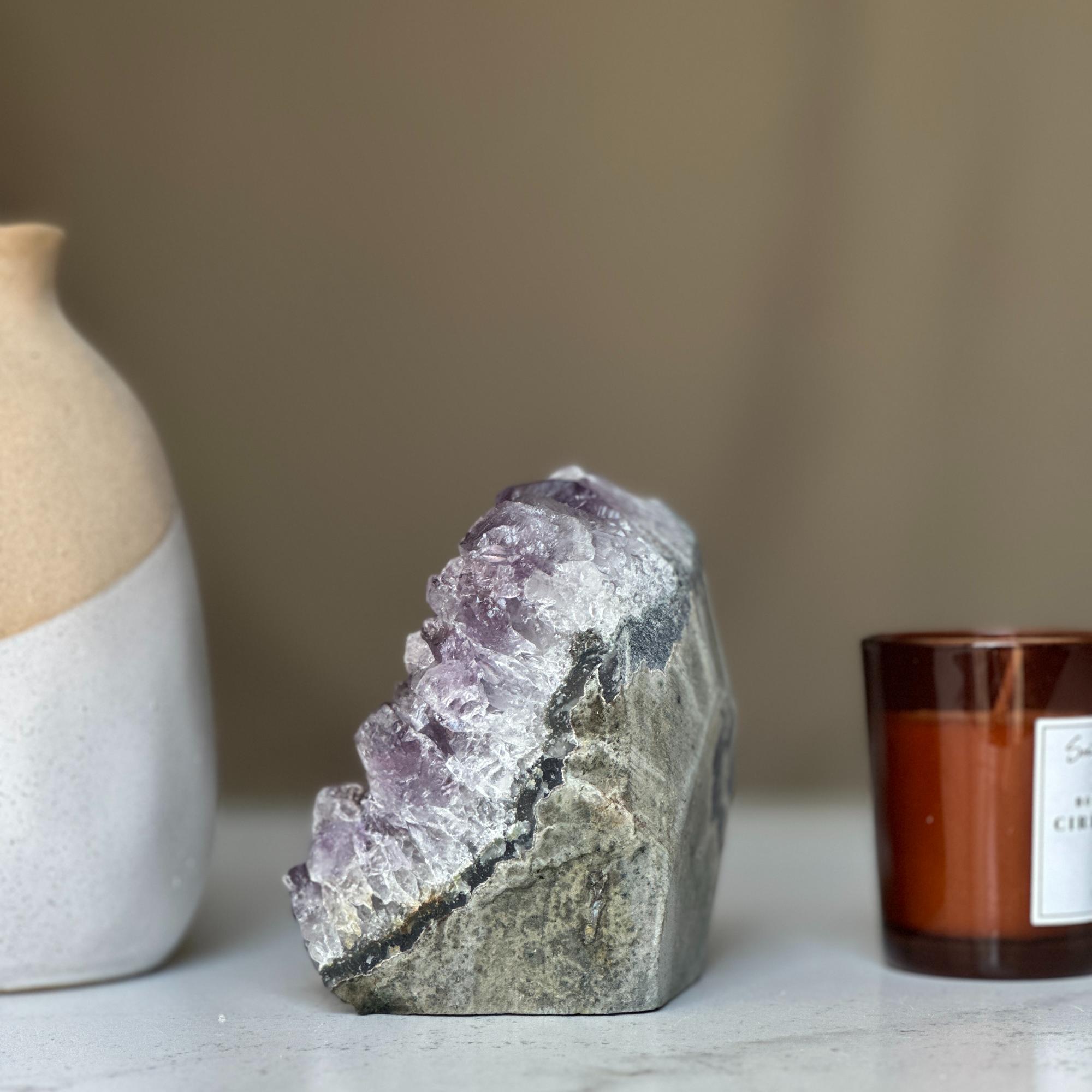Large, deep purple amethyst geode cluster from Uruguay, 4 inches tall, with a rough gray exterior.