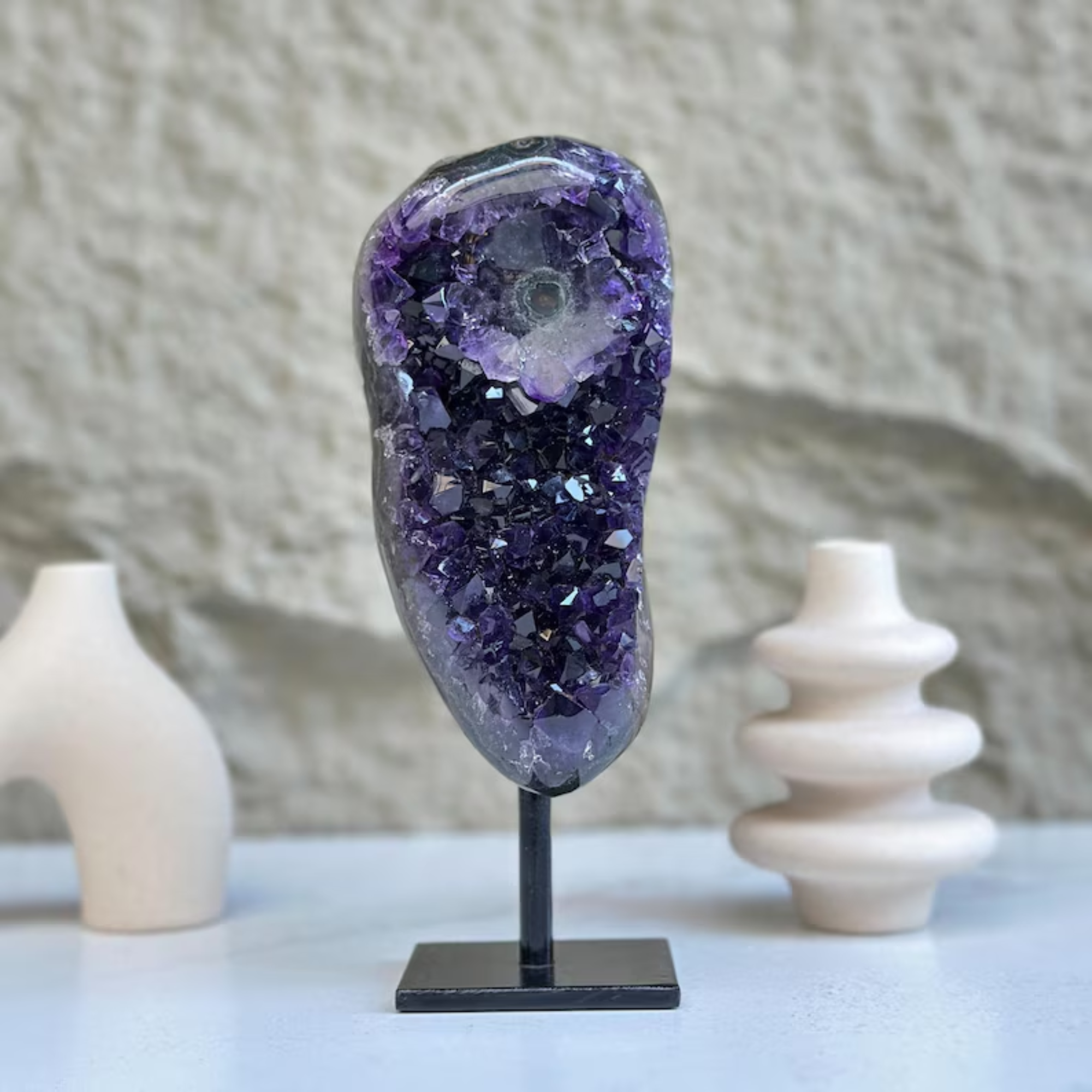 Stunning 8-inch self-standing amethyst geode with sparkly deep purple crystals on a black metal stand.