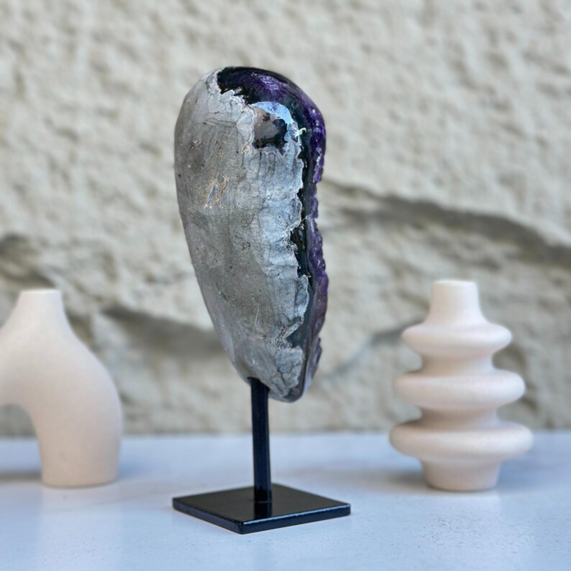Self-standing amethyst geode, 8-inch tall, with sparkling purple crystals on a black metal stand.