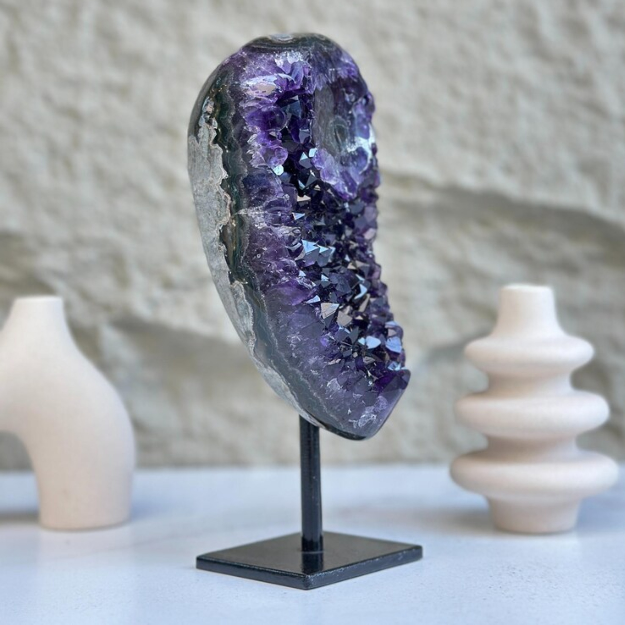 Stunning 8-inch tall, 2 lb self-standing amethyst geode with sparkly purple crystals on a black metal stand.