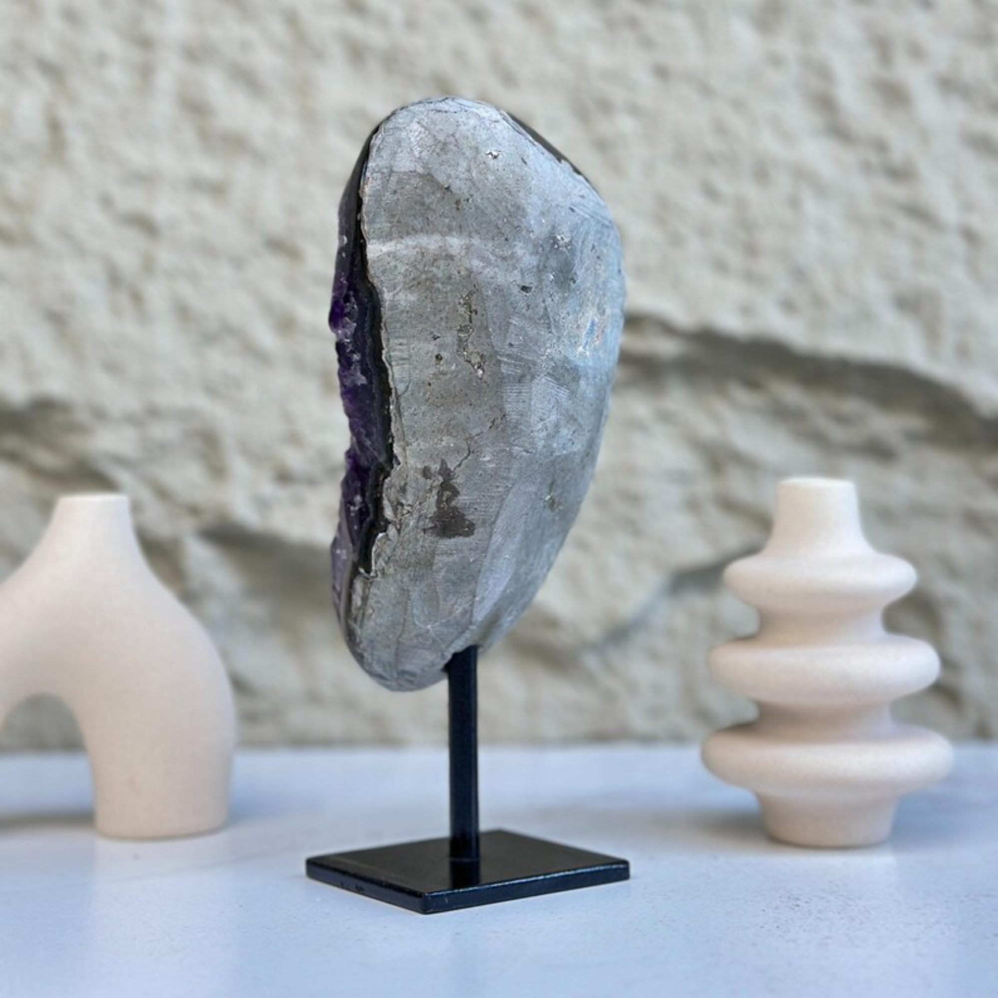 Self-standing 8-inch Uruguayan amethyst geode with sparkly purple crystals on a black stand.
