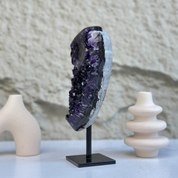 Stunning 8-inch self-standing amethyst geode with sparkly deep purple crystals on a black stand.