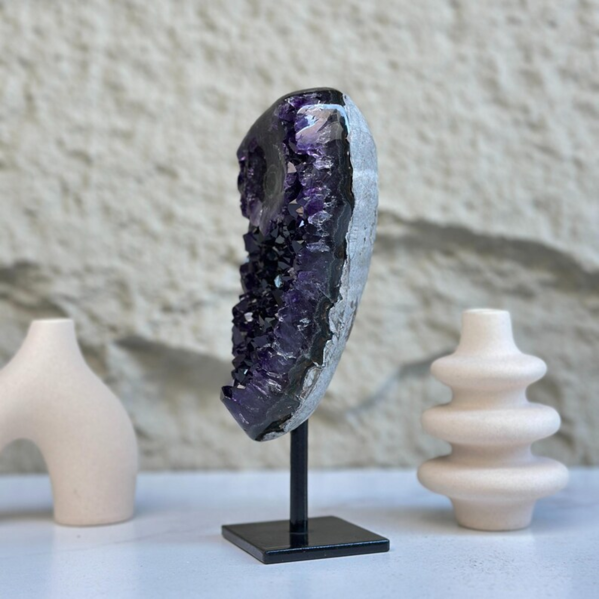 Stunning 8-inch self-standing amethyst geode with sparkly deep purple crystals on a black stand.