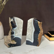 Pair of natural dark amethyst and agate geode bookends with white crystal centers.