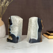 Pair of natural amethyst and agate geode bookends with deep purple crystals and white banding.