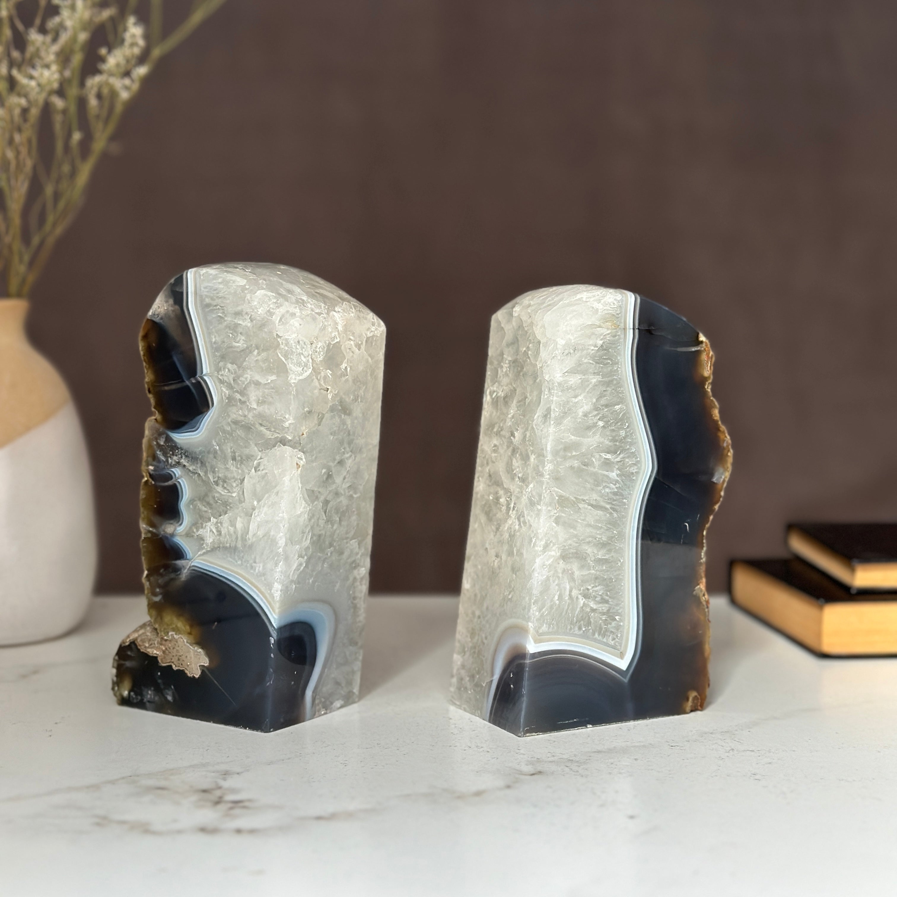 Pair of natural amethyst and agate geode bookends with deep purple crystals and white banding.