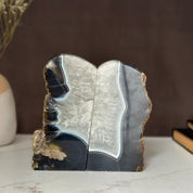 Pair of polished amethyst and agate geode bookends with deep purple crystals and natural banding.