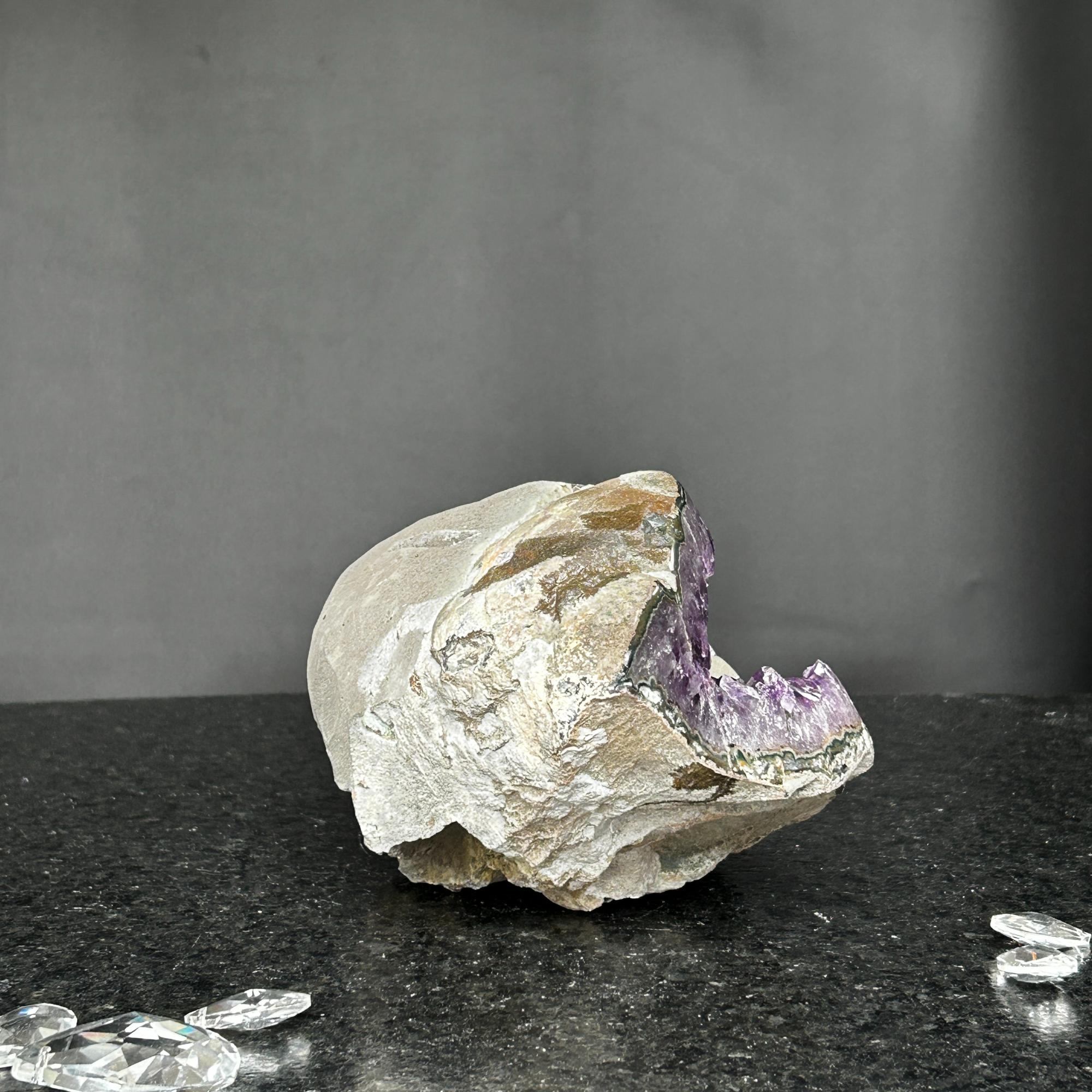 Vibrant deep purple Uruguayan amethyst geode, 9.5x5 inches, with rough natural rock exterior.