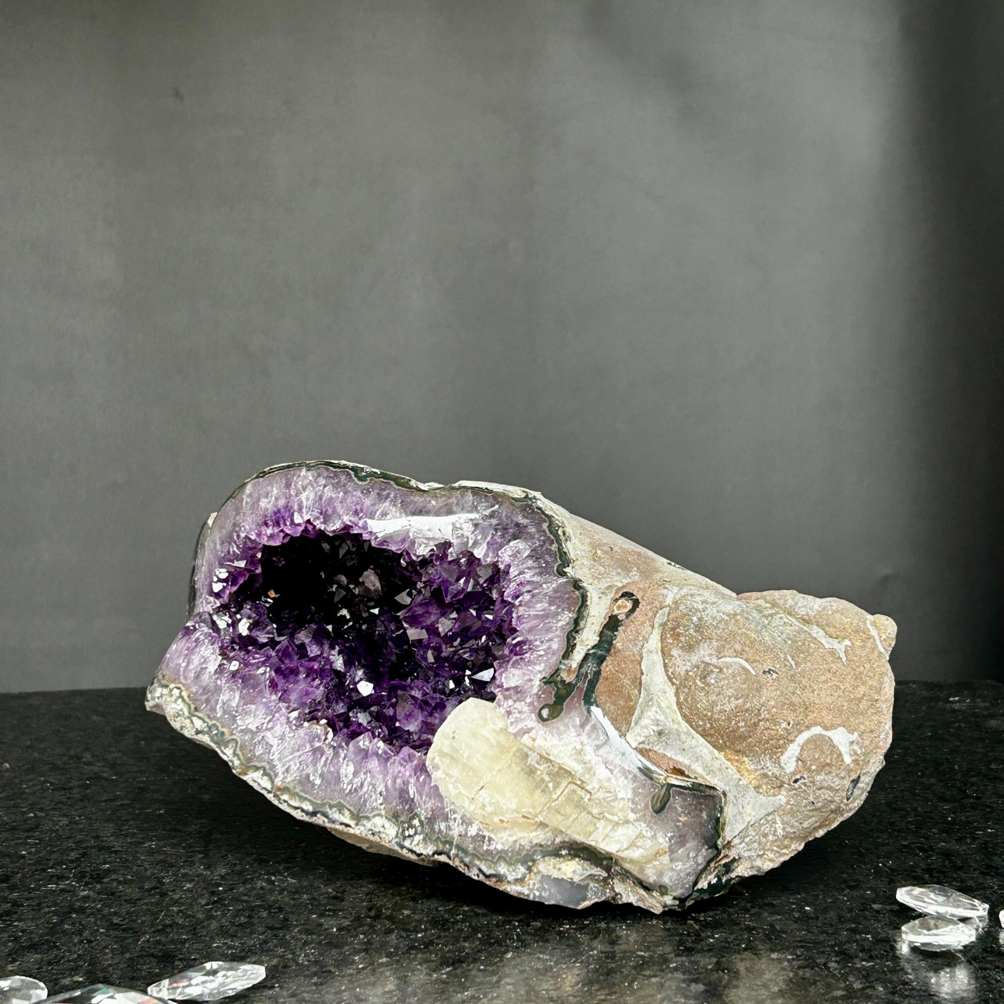 Large Uruguayan amethyst geode, 9.5x5 inch, with deep purple crystals and natural rock exterior.