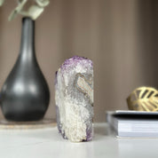 Self-standing amethyst cathedral geode with deep purple crystals and natural white/grey rock.