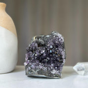Polished deep purple amethyst cluster geode with sparkling druzy crystals and dark agate. 4 inches tall.