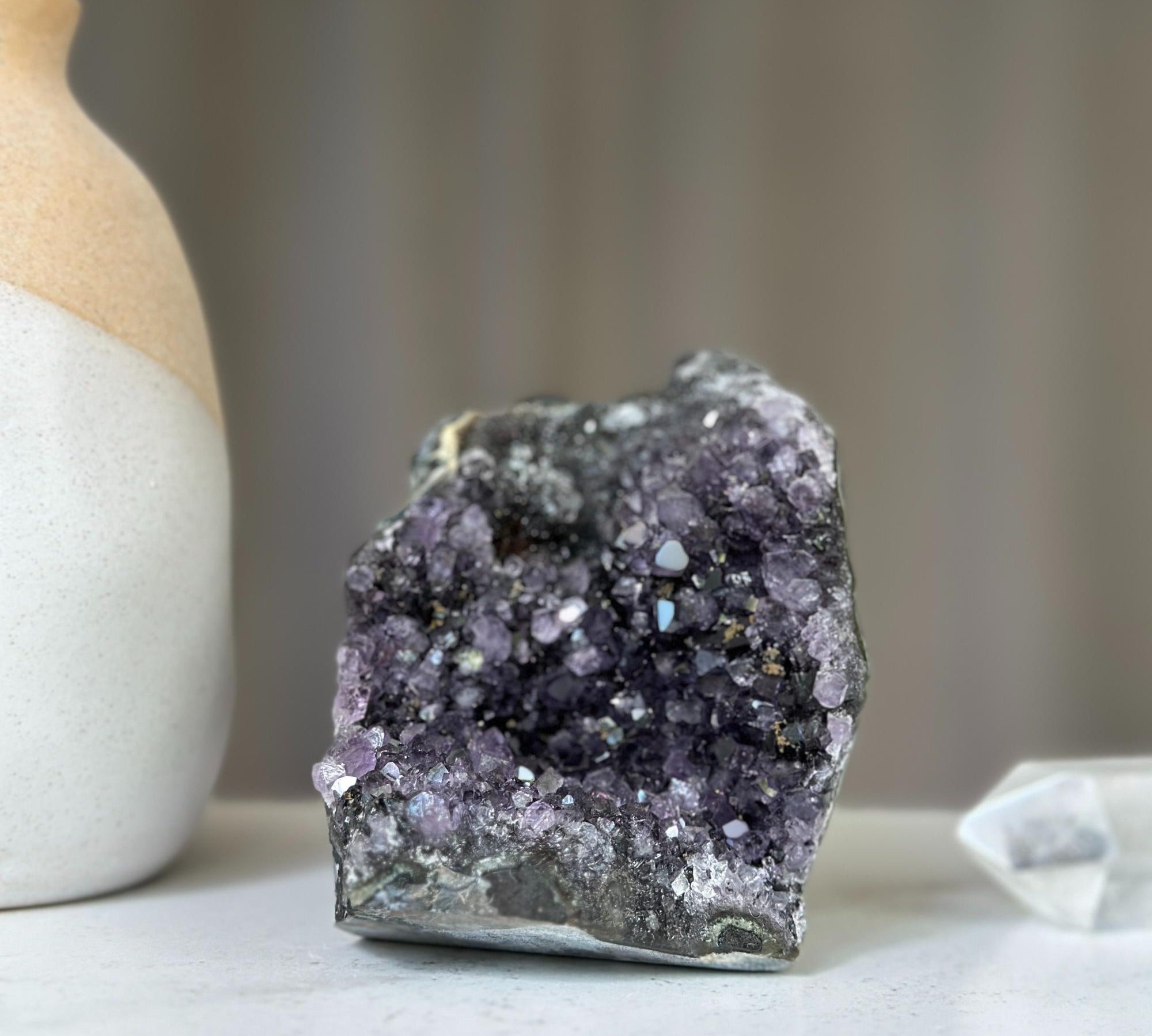 Polished deep purple amethyst cluster geode with sparkling druzy crystals and dark agate. 4 inches tall.