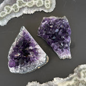 Two deep purple Uruguayan amethyst clusters with sparkling crystals, ideal for home decor.