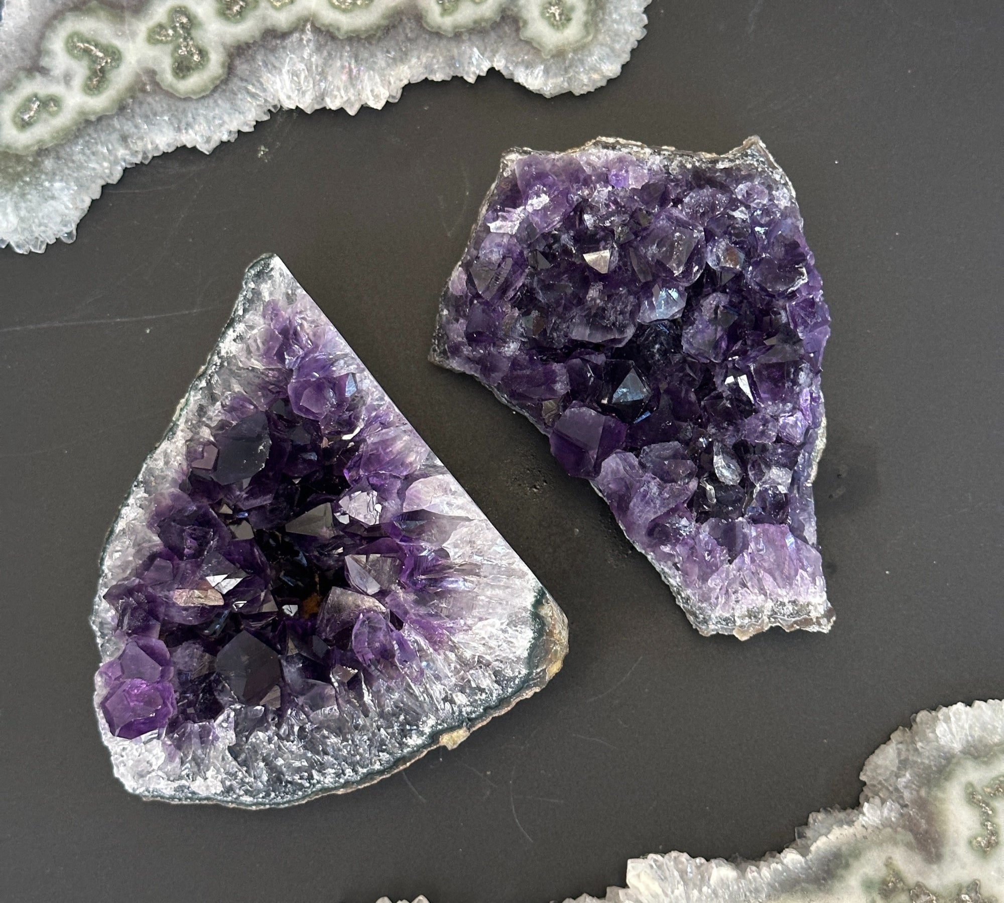 Two deep purple Uruguayan amethyst clusters with sparkling crystals, ideal for home decor.
