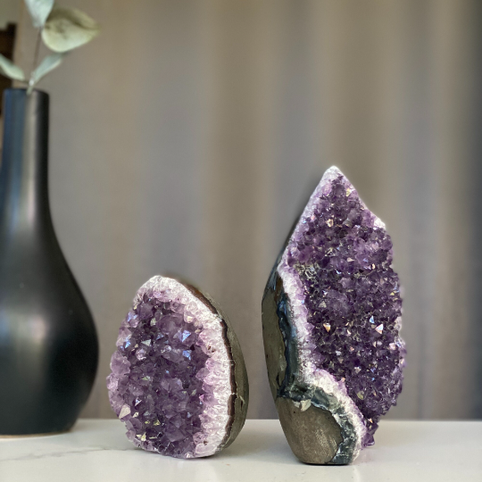 Set of two natural amethyst flame geodes featuring deep purple druzy crystals and grey agate banding.
