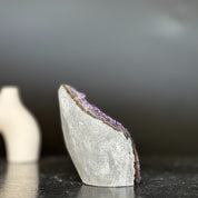 Polished amethyst geode flame with purple crystals and grey-brown agate edges, 4-inch tall.