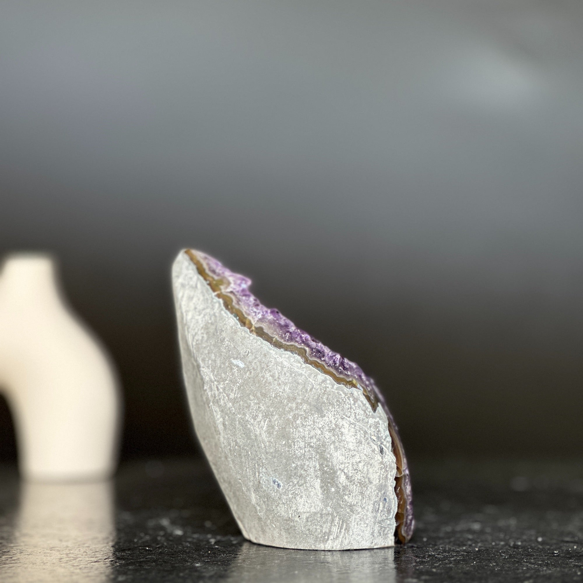 Polished amethyst geode flame with purple crystals and grey-brown agate edges, 4-inch tall.