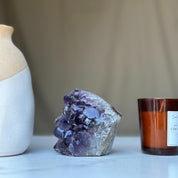 Vibrant deep purple amethyst geode crystal cluster, a large natural semi-precious stone.