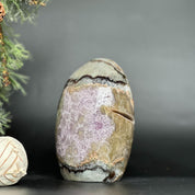 Egg-shaped Uruguayan amethyst geode with deep purple crystals and natural agate edges.