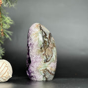 Deep purple amethyst geode, egg-shaped, with natural agate edges and a sparkling crystal interior.