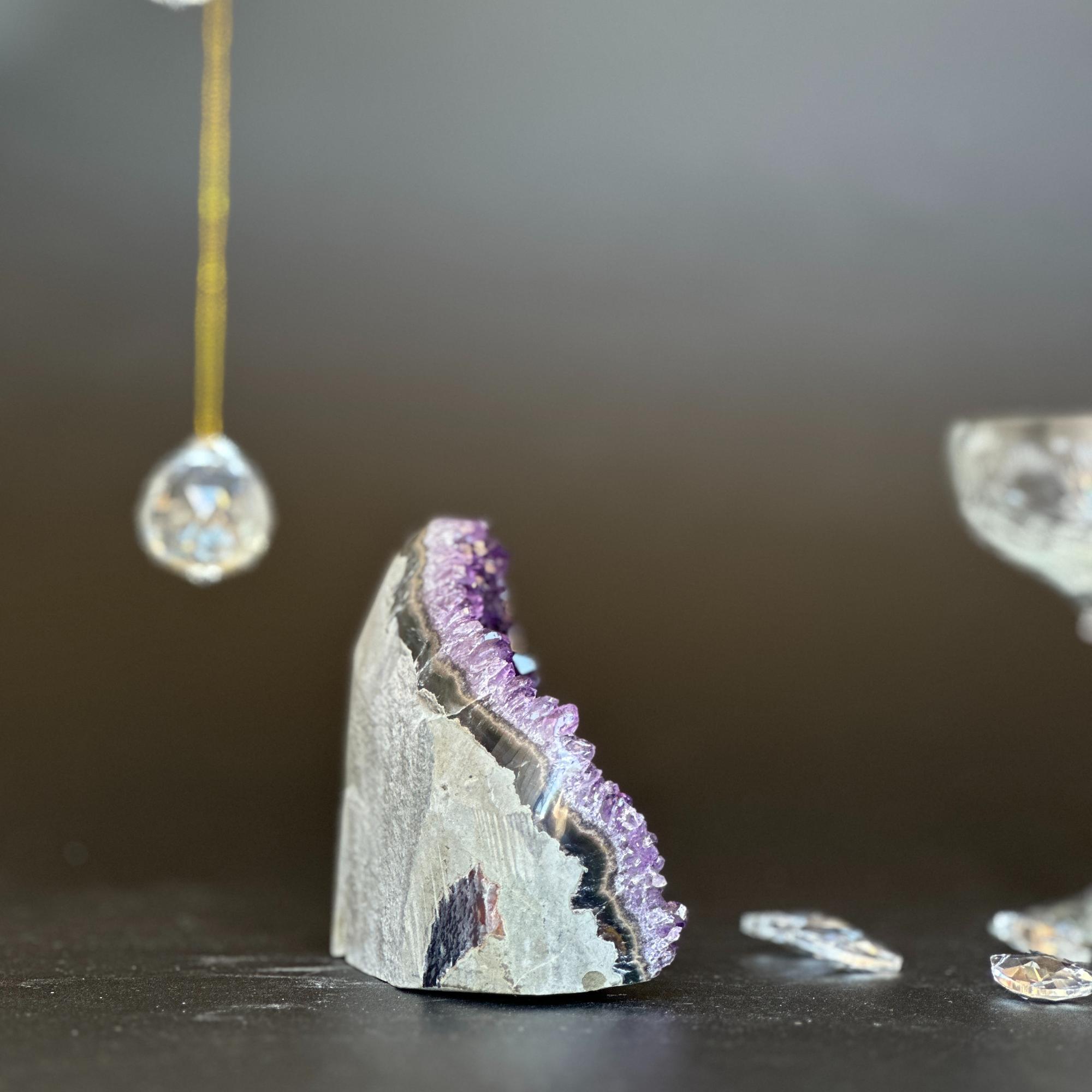 Unique raw amethyst geode crystal cluster with deep purple crystals and natural gray rock.