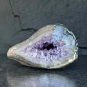 Sparkling deep purple amethyst geode from Uruguay, featuring natural crystal formations and a self-standing base.