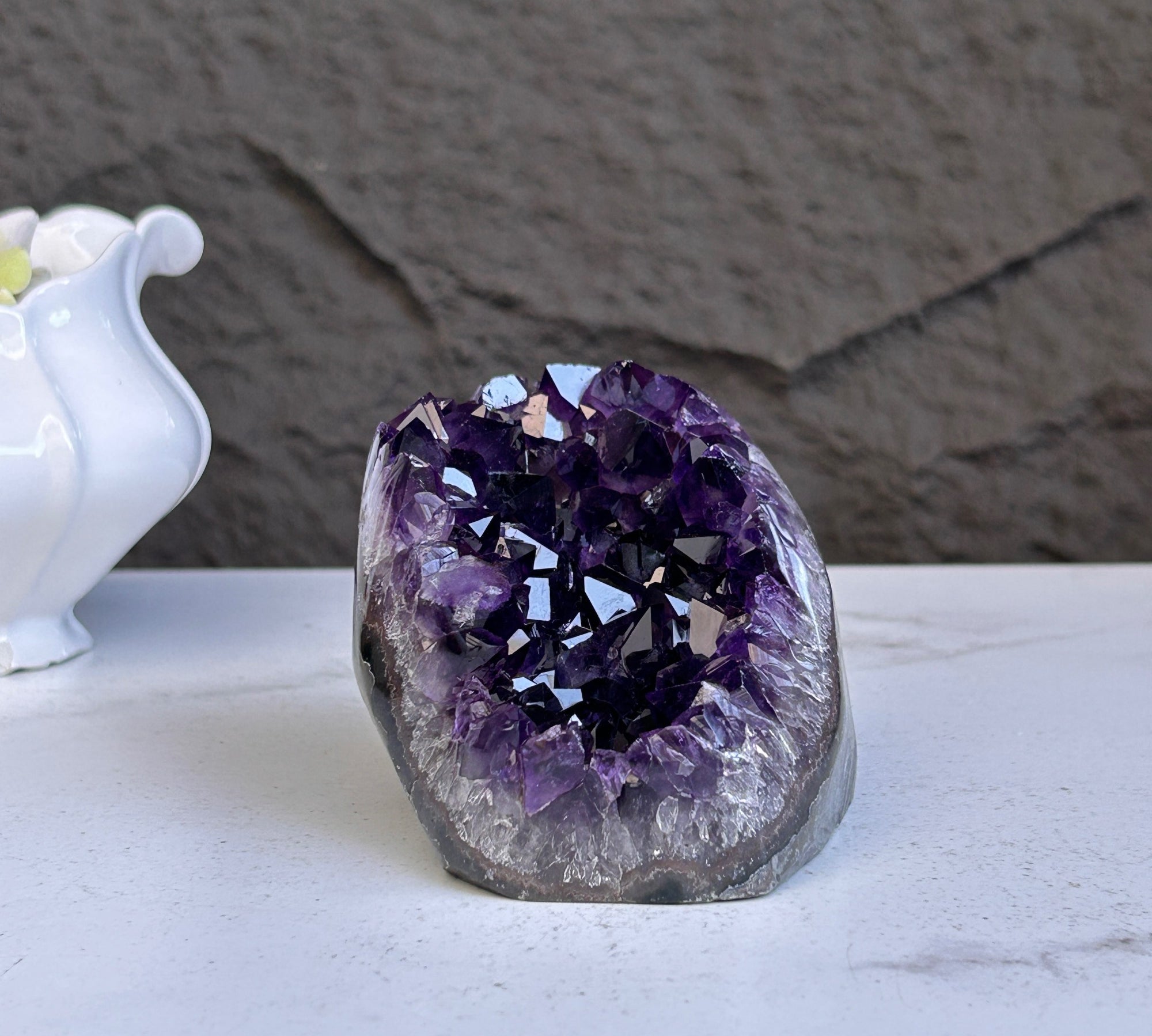 Deep purple Uruguayan amethyst geode with sparkling crystals and agate formations.