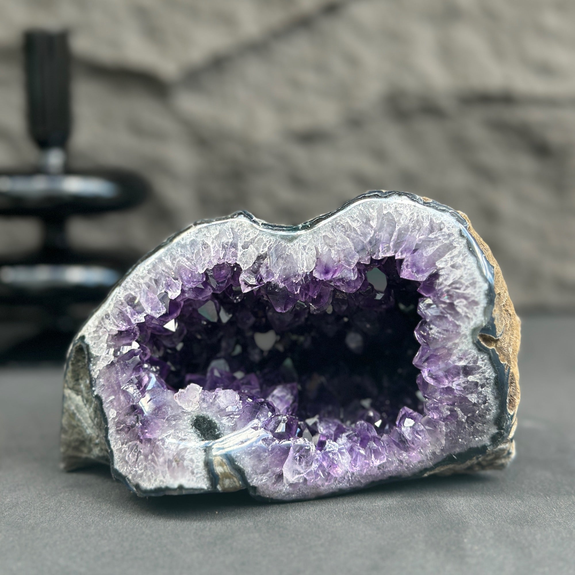 Uruguayan amethyst geode, 6x3.5 inches, with deep purple crystals and natural rock exterior.