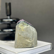 Deep purple Uruguayan cathedral amethyst raw stone, 4-inch tall, with natural gray-green rock base.