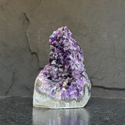 Extra large Uruguayan amethyst geode with deep purple crystals and natural agate formations.