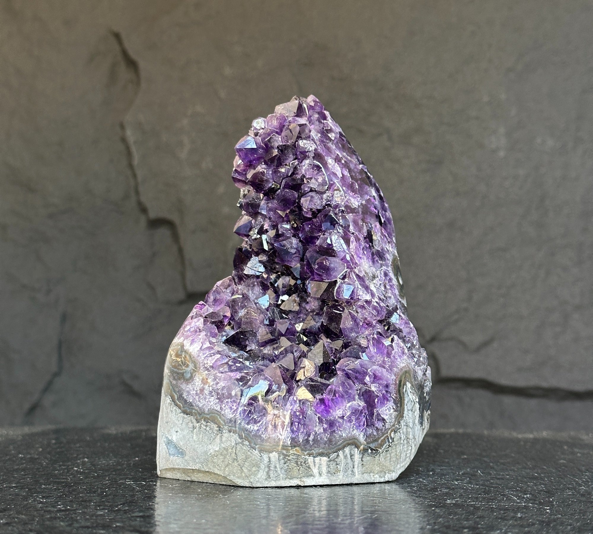 Extra large Uruguayan amethyst geode with deep purple crystals and natural agate formations.