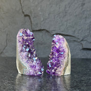 Two deep purple Uruguayan amethyst geode clusters, 3-inch high, on a dark surface.
