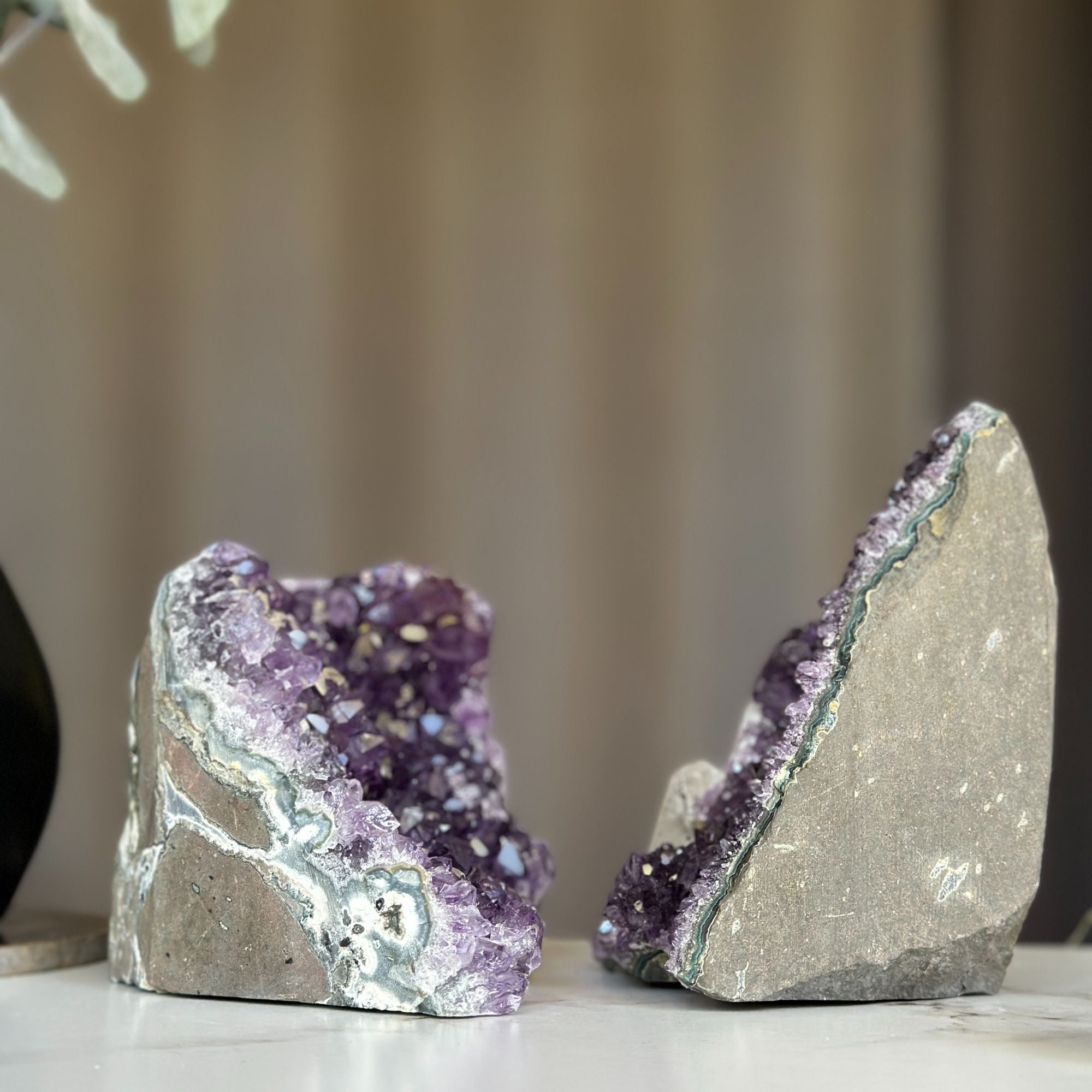 Two deep purple amethyst geodes with calcite formations, weighing 3.9 lb.