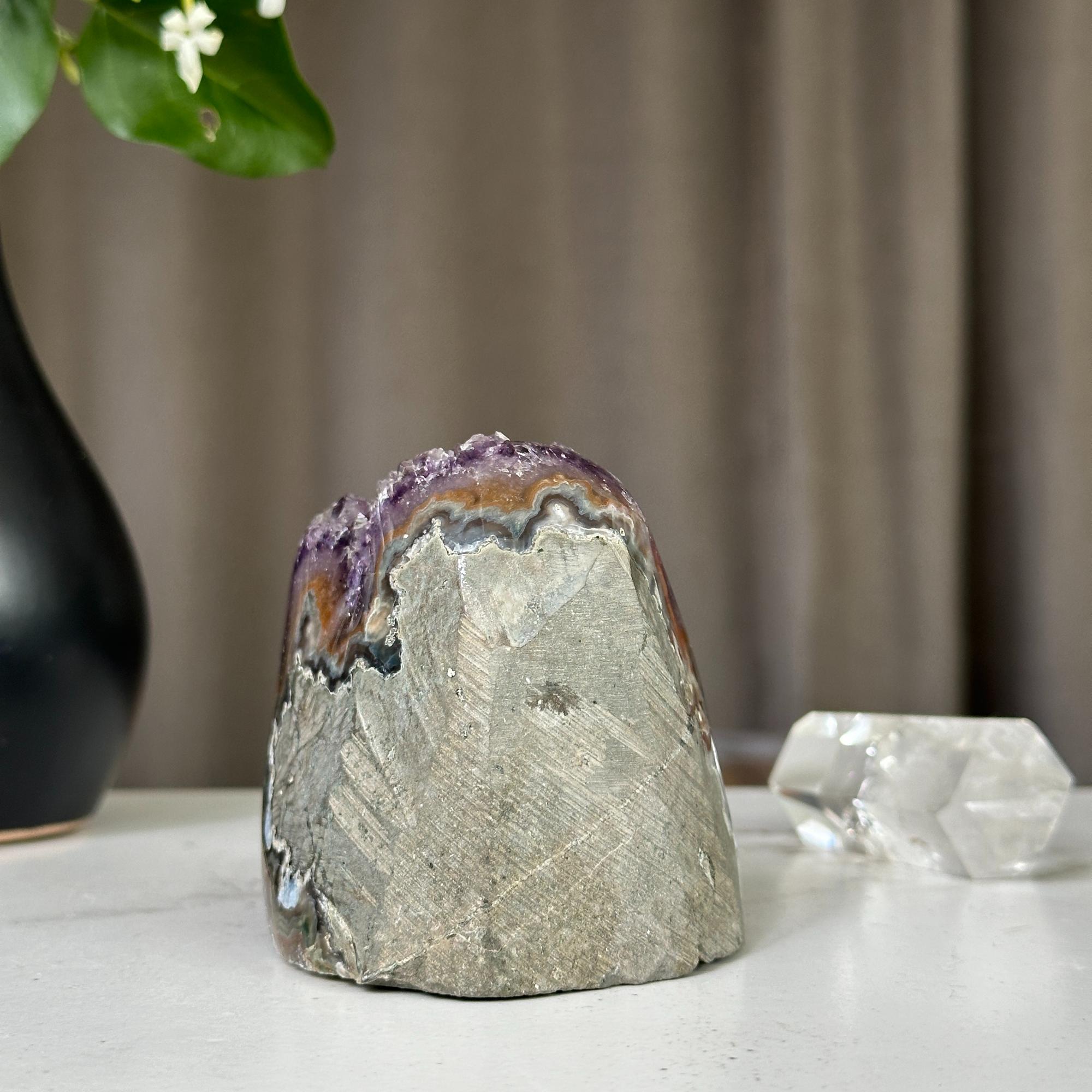 Deep purple Uruguayan amethyst crystal geode, 3x3 inch, with raw grey exterior.
