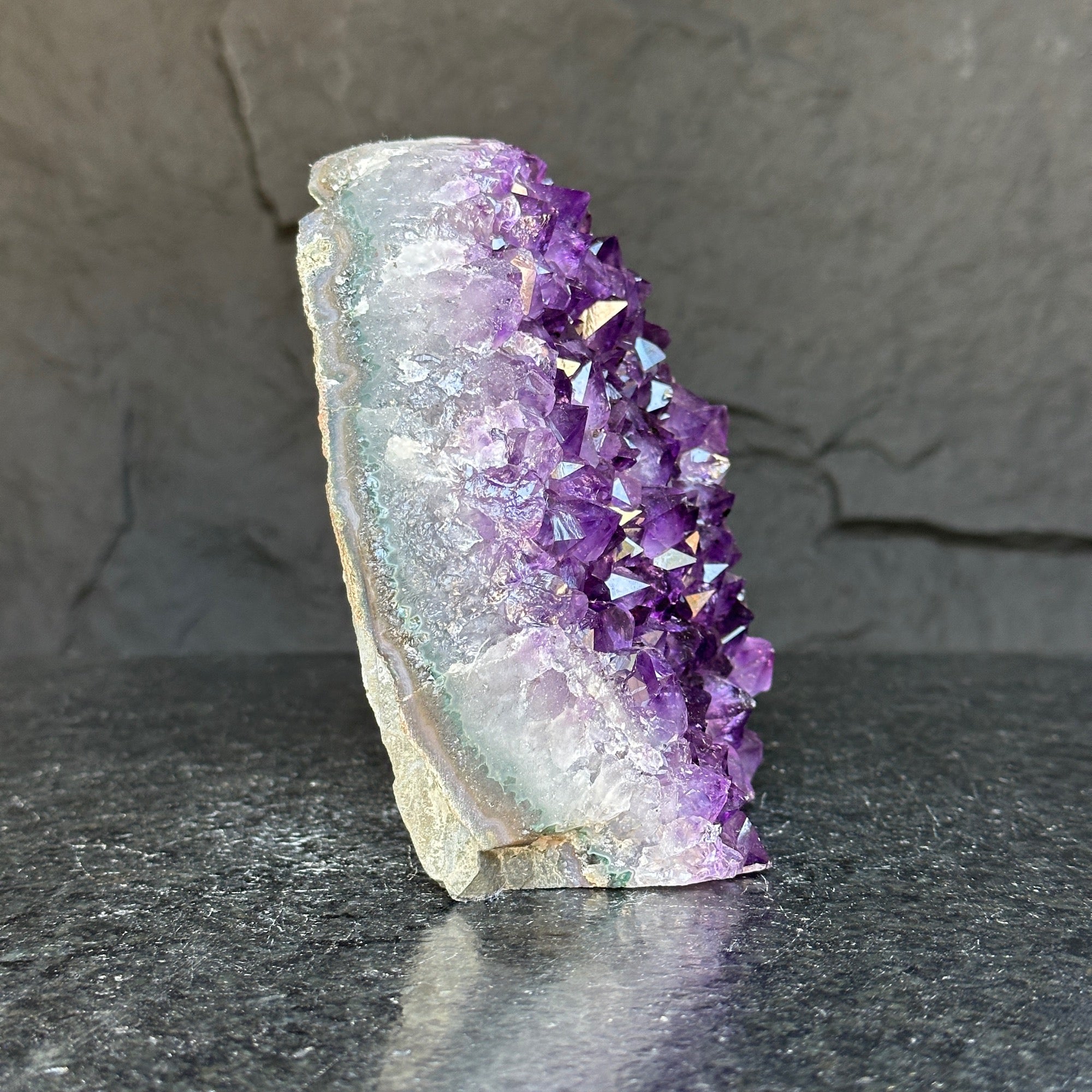 Deep purple Uruguayan amethyst cathedral geode with sparkling crystal points and calcite formation.