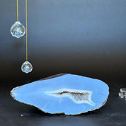 Uruguayan agate geode with a light blue exterior and sparkling white crystal cave.