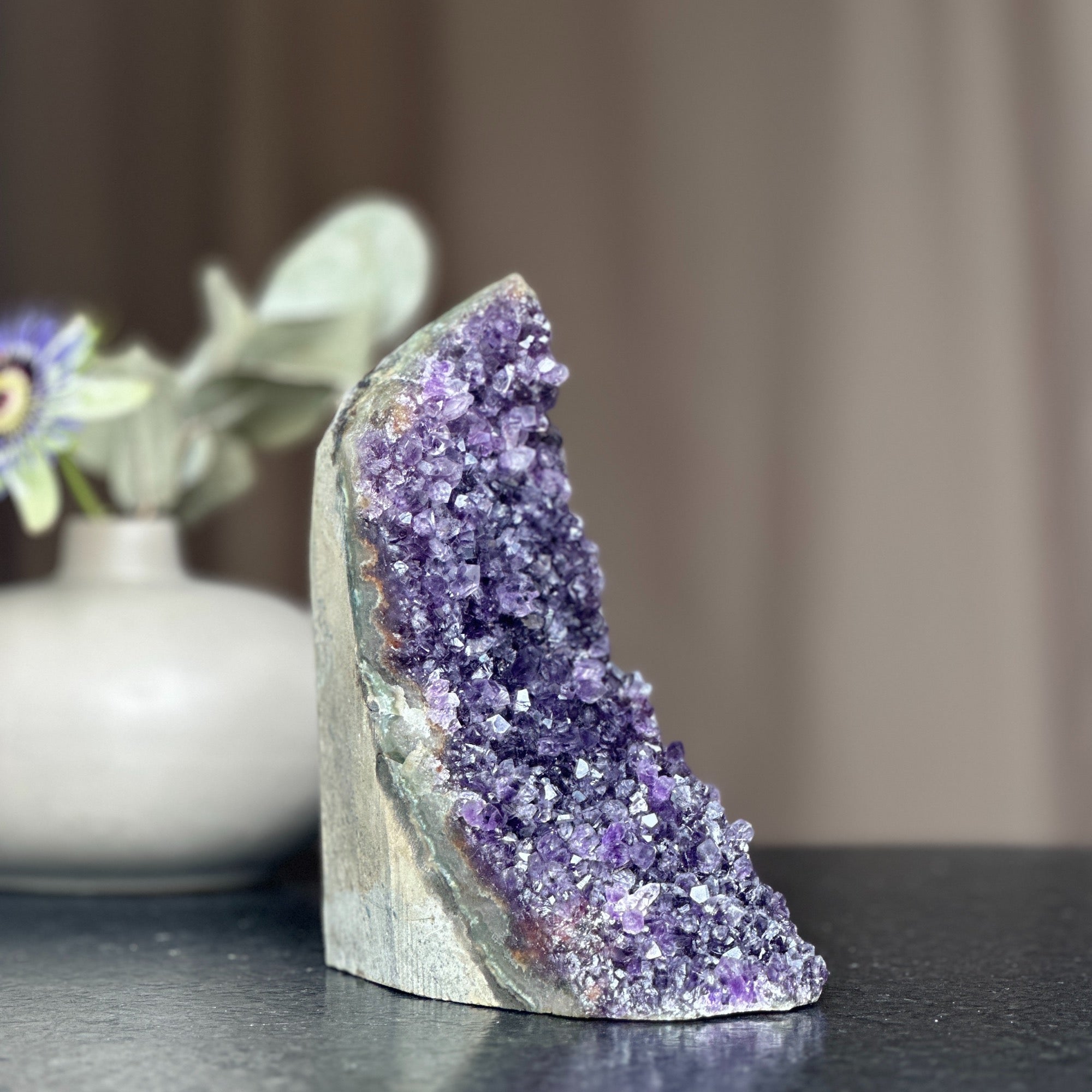 Huge deep purple amethyst crystal cluster geode with a cut base, 6.5 inches tall.