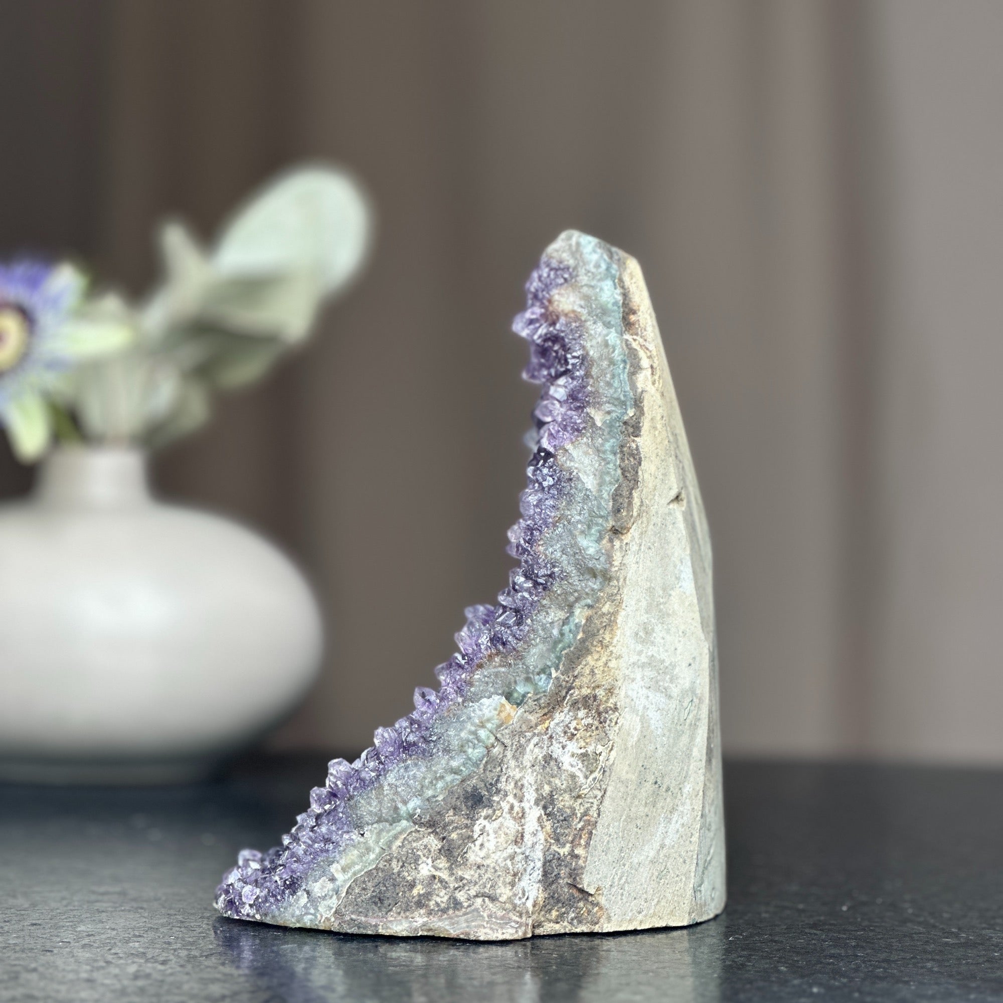 Huge deep purple amethyst crystal geode cluster with a cut base, 6.5 inches tall.